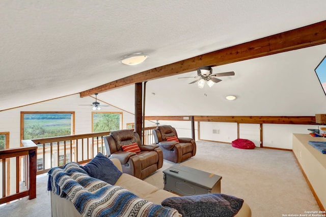 carpeted living room with lofted ceiling with beams, a ceiling fan, and a textured ceiling