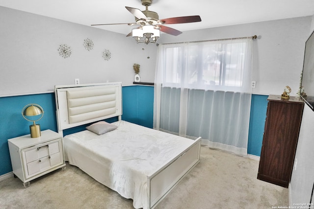 carpeted bedroom featuring baseboards and ceiling fan