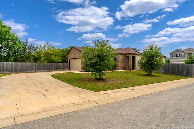 4650 Trevor Way, San Antonio, TX 78217 - view of front of property with brick siding, fence, roof mounted solar panels, driveway, and a front yard
