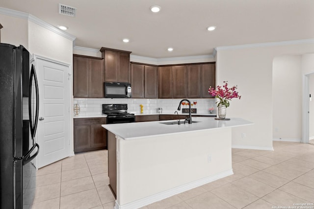 4650 Trevor Way, San Antonio, TX 78217 - kitchen with a sink, light tile patterned floors, black appliances, visible vents, and an island with sink
