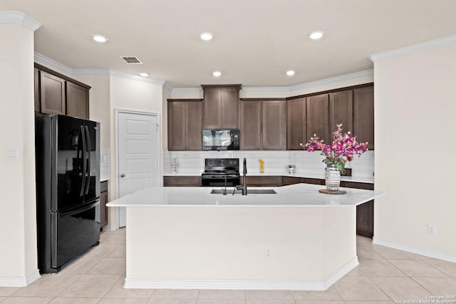 4650 Trevor Way, San Antonio, TX 78217 - kitchen featuring a sink, decorative backsplash, a center island with sink, black appliances, and dark brown cabinetry