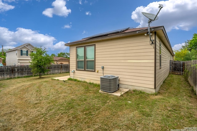 4650 Trevor Way, San Antonio, TX 78217 - back of property featuring roof mounted solar panels, a yard, central AC unit, and a fenced backyard