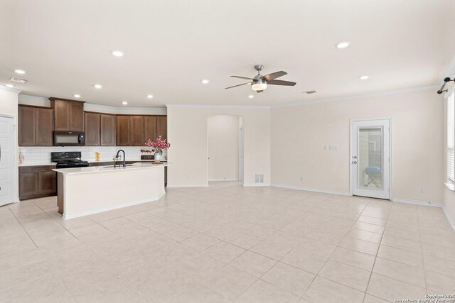 4650 Trevor Way, San Antonio, TX 78217 - kitchen featuring ceiling fan, black appliances, open floor plan, backsplash, and an island with sink