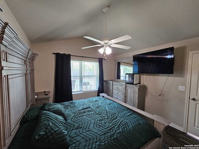943 Patton, San Antonio, TX 78237 - bedroom with a textured ceiling, ceiling fan, dark wood-style floors, baseboards, and vaulted ceiling