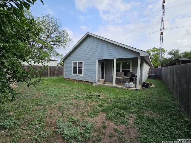 943 Patton, San Antonio, TX 78237 - rear view of house with a yard, a fenced backyard, and a patio area