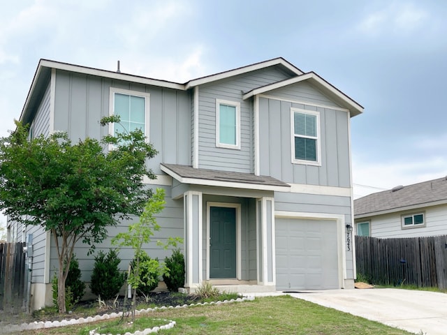 traditional-style home with a garage, fence, board and batten siding, and driveway