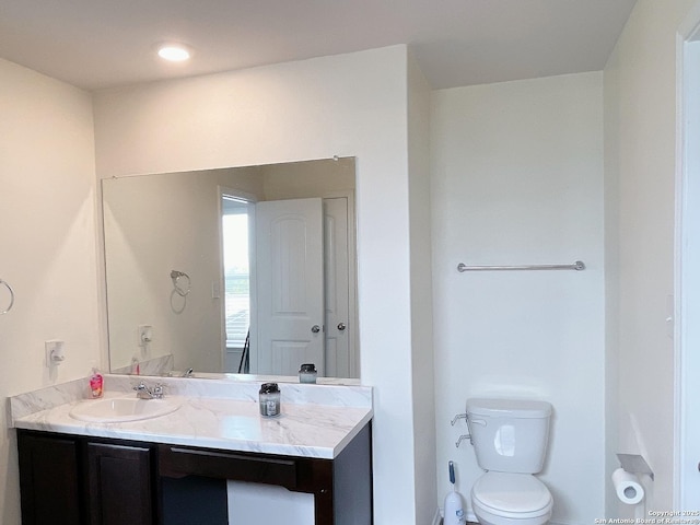 bathroom featuring toilet and vanity