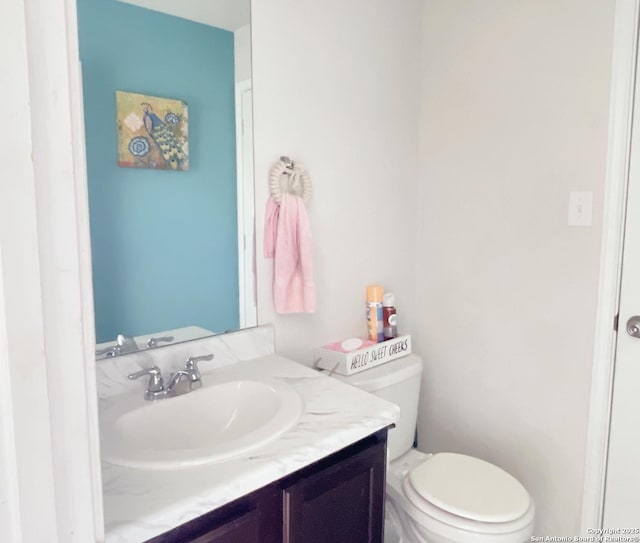 half bathroom featuring toilet and vanity