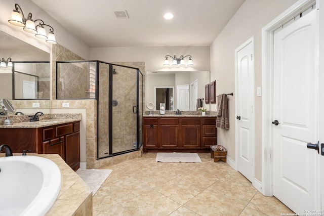 bathroom with a shower stall, visible vents, two vanities, a bath, and tile patterned floors