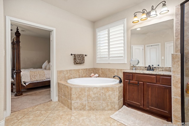 ensuite bathroom featuring ensuite bathroom, tile patterned flooring, a bath, and vanity