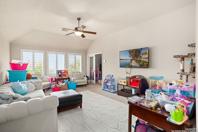 carpeted living room featuring a ceiling fan, visible vents, and vaulted ceiling