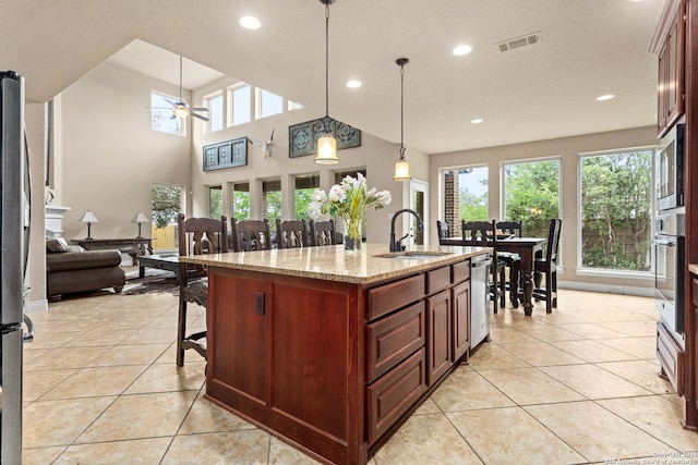 kitchen featuring appliances with stainless steel finishes, ceiling fan, a sink, visible vents, and light tile patterned flooring
