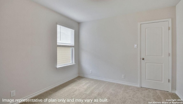 unfurnished room with carpet flooring and baseboards