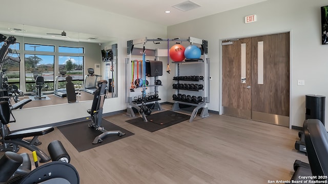 exercise room featuring recessed lighting, a ceiling fan, wood finished floors, and baseboards