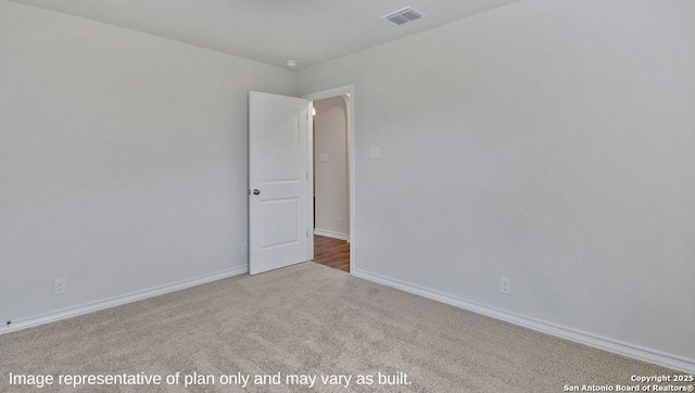 carpeted spare room with baseboards and visible vents