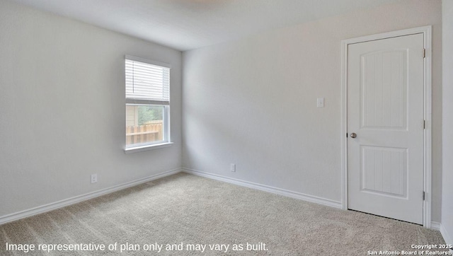 empty room with baseboards and carpet