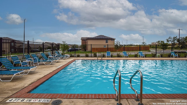 pool featuring a patio and fence