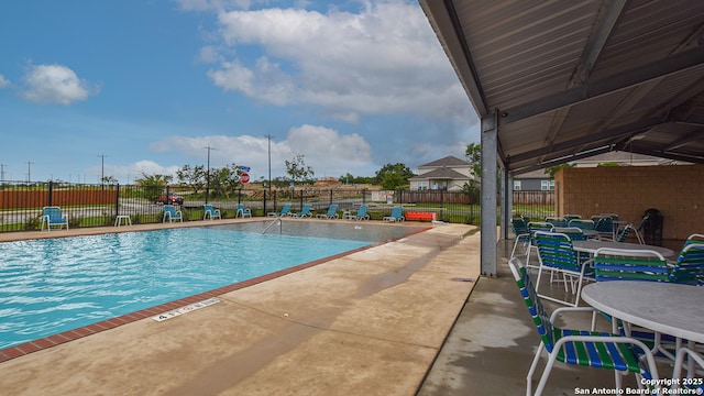 pool with fence and a patio area
