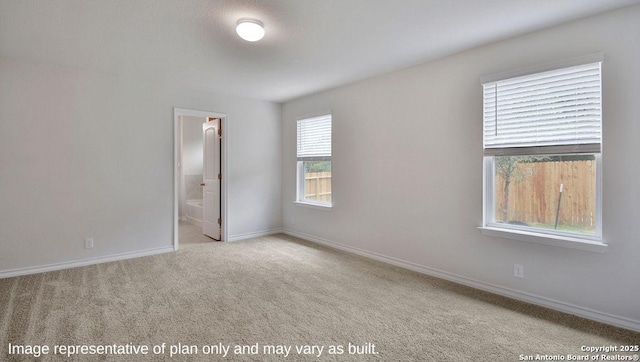 empty room with carpet and baseboards