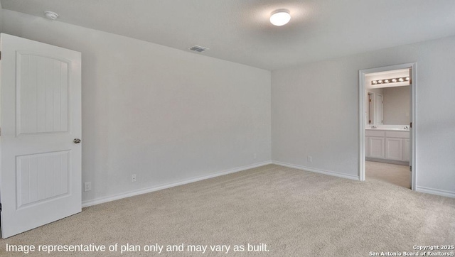 unfurnished bedroom featuring baseboards, visible vents, ensuite bathroom, and carpet flooring