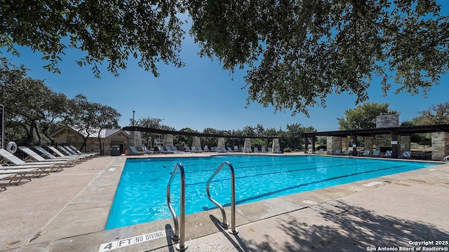 community pool with a patio area