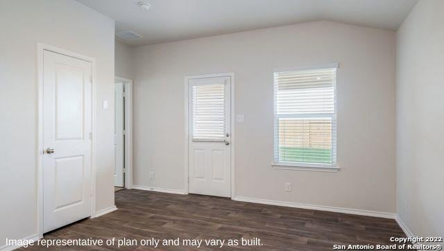 5055 Wichita Pike, San Antonio, TX 78253 - unfurnished bedroom featuring dark wood-style flooring, vaulted ceiling, and baseboards