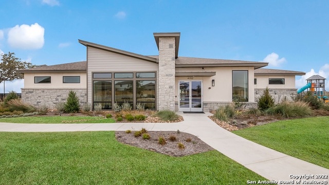 5055 Wichita Pike, San Antonio, TX 78253 - back of house with a lawn, stucco siding, and stone siding