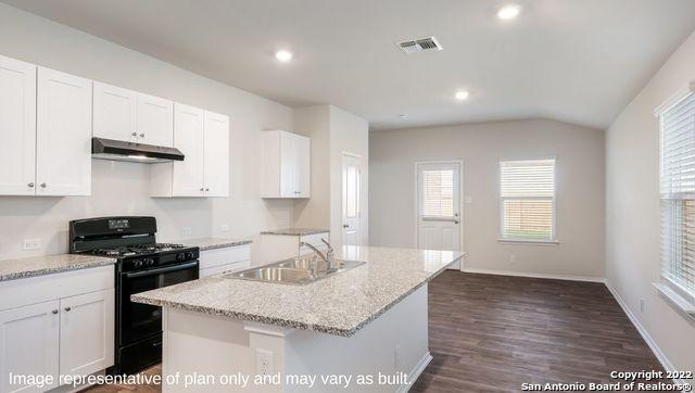 5055 Wichita Pike, San Antonio, TX 78253 - kitchen with white cabinets, a sink, black gas stove, visible vents, and under cabinet range hood