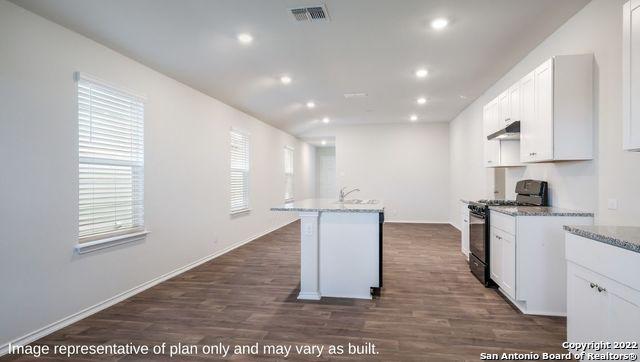 5055 Wichita Pike, San Antonio, TX 78253 - kitchen with recessed lighting, dark wood-style flooring, visible vents, black gas range oven, and white cabinets