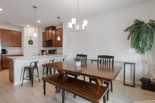 dining room featuring a chandelier, visible vents, baseboards, recessed lighting, and light wood finished floors