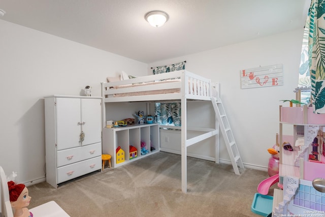 bedroom featuring baseboards and carpet