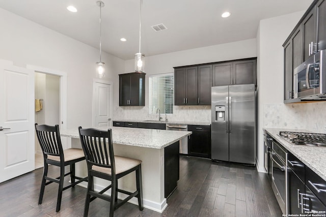 kitchen featuring a sink, visible vents, appliances with stainless steel finishes, and dark wood-style flooring