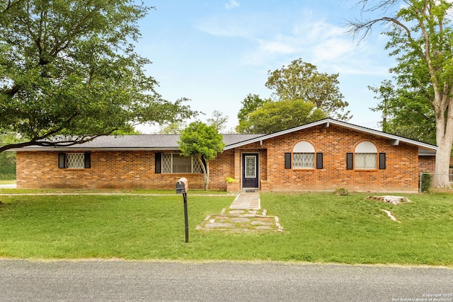 114 Nueces, Seguin, TX 78155 - ranch-style home featuring brick siding and a front lawn