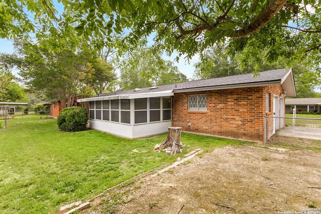 114 Nueces, Seguin, TX 78155 - back of property with brick siding, fence, a yard, and a sunroom