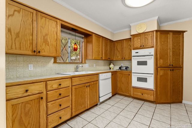 114 Nueces, Seguin, TX 78155 - kitchen featuring crown molding, a sink, tasteful backsplash, and white appliances