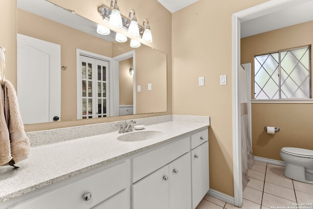 114 Nueces, Seguin, TX 78155 - bathroom featuring baseboards, toilet, tile patterned flooring, and vanity