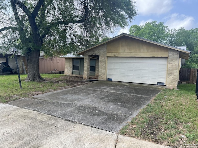 7322 Goya, San Antonio, TX 78239 - single story home with concrete driveway, a front yard, fence, brick siding, and a garage