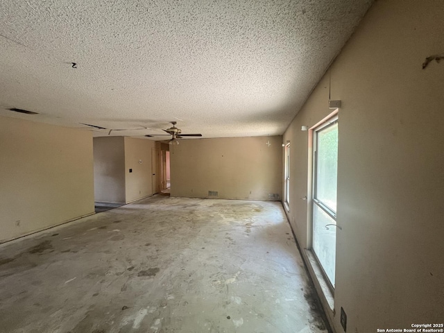 7322 Goya, San Antonio, TX 78239 - spare room with a textured ceiling, a ceiling fan, and concrete floors
