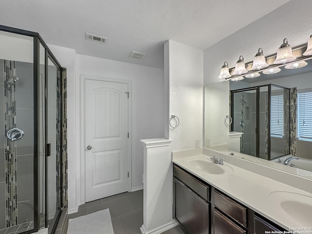 full bath with tile patterned flooring, a shower stall, double vanity, a sink, and visible vents