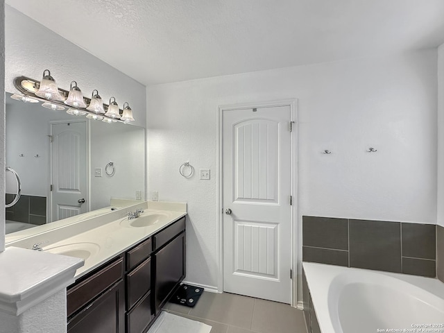 full bathroom with tile patterned floors, a tub, double vanity, and a sink