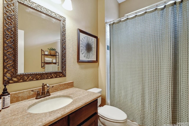 19538 Azure Oak, San Antonio, TX 78258 - full bathroom with curtained shower, a textured wall, toilet, and vanity