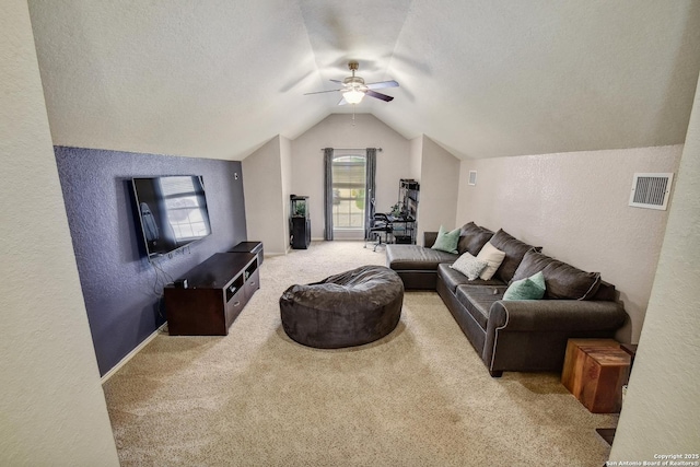 19538 Azure Oak, San Antonio, TX 78258 - carpeted living room with visible vents, a textured wall, vaulted ceiling, and ceiling fan