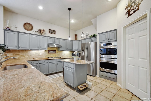 19538 Azure Oak, San Antonio, TX 78258 - kitchen featuring a sink, decorative backsplash, stainless steel appliances, under cabinet range hood, and gray cabinetry