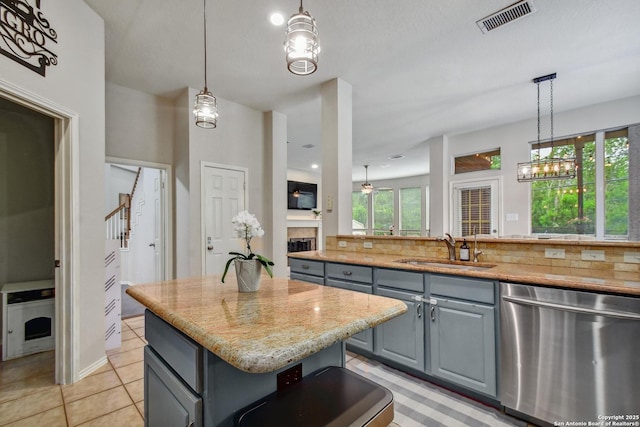 19538 Azure Oak, San Antonio, TX 78258 - kitchen with stainless steel dishwasher, a sink, visible vents, a center island, and gray cabinets