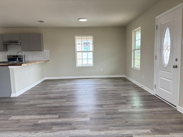 708 E 5th, Nixon, TX 78140 - interior space with visible vents, baseboards, and dark wood finished floors