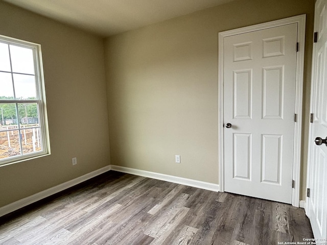 708 E 5th, Nixon, TX 78140 - spare room with dark wood-style flooring and baseboards