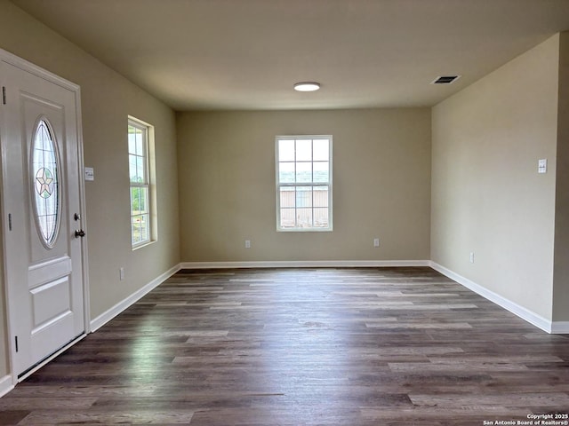 708 E 5th, Nixon, TX 78140 - entrance foyer featuring baseboards, visible vents, dark wood finished floors, and plenty of natural light