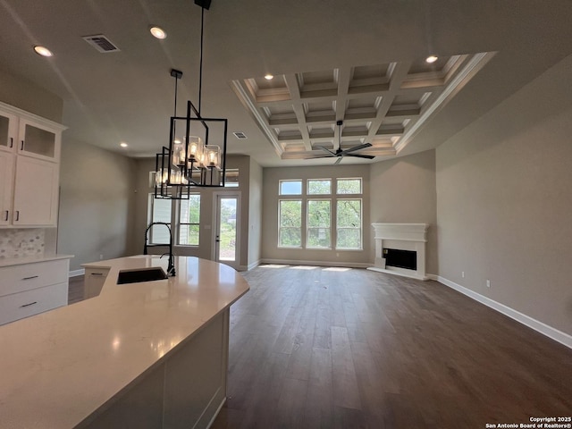 kitchen with recessed lighting, ceiling fan with notable chandelier, dark wood finished floors, and a sink