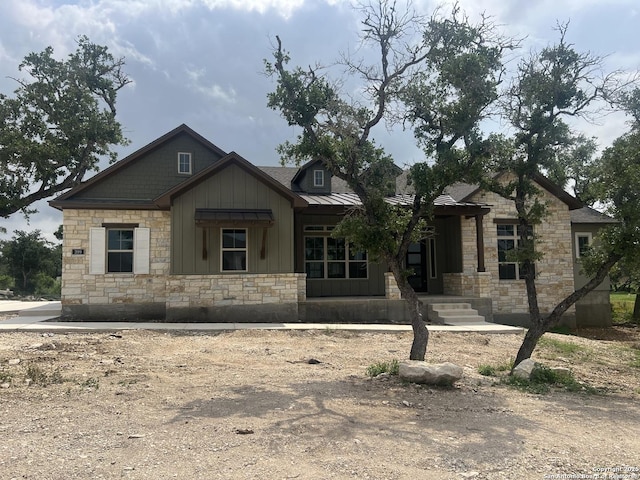 view of front of house featuring stone siding and board and batten siding