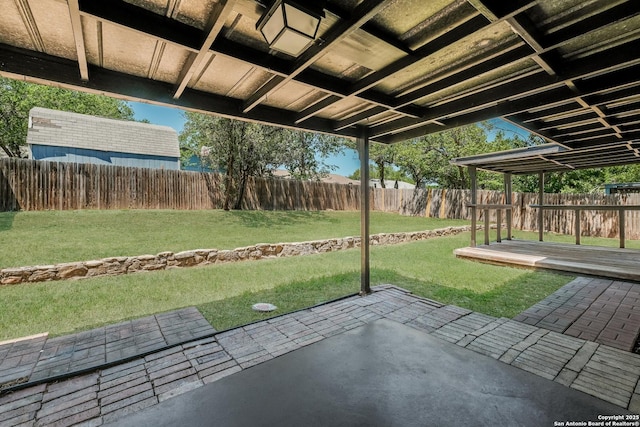 view of patio featuring a deck and a fenced backyard